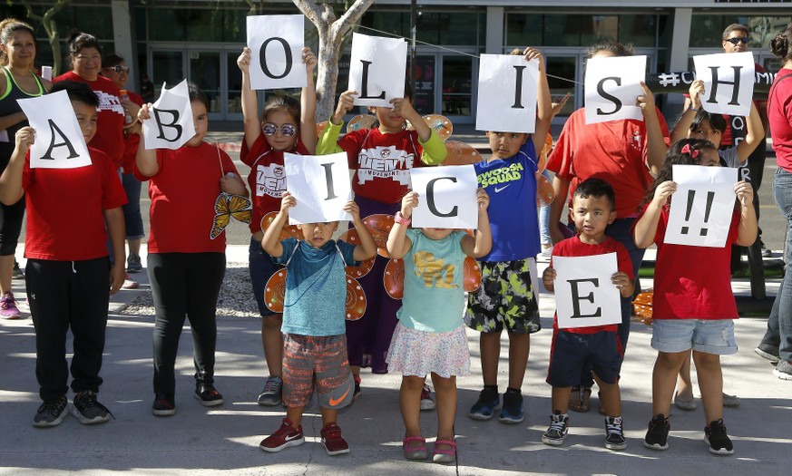 Kids hold up signs during an immigration family separation protest in front of the Sandra Day O&#039;Connor U.S. District Court building, Monday, June 18, 2018, in Phoenix. An unapologetic President D ...