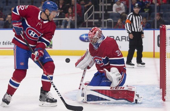 Montreal Canadiens goalie Carey Price, right, makes a save as teammate Mark Streit skates to the net against the Toronto Maple Leafs during the first period of a preseason NHL hockey game, Wednesday,  ...