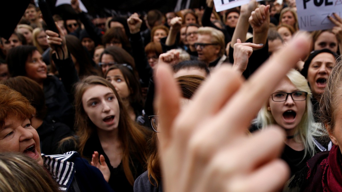 A woman gestures as people gather in an abortion rights campaigners' demonstration to protest against plans for a total ban on abortion in front of the ruling party Law and Justice (PiS) headquar ...