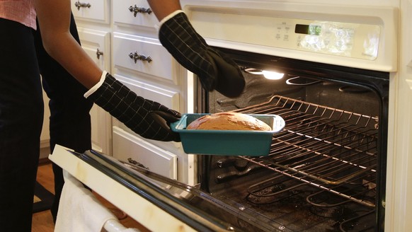 In this Friday, Oct. 30, 2015 photo, 13-year-old chef Chase Bailey takes a holiday spice pound cake out of the oven in Irvine, Calif. Diagnosed with autism at 2, BaileyÂs mother feared her son would  ...