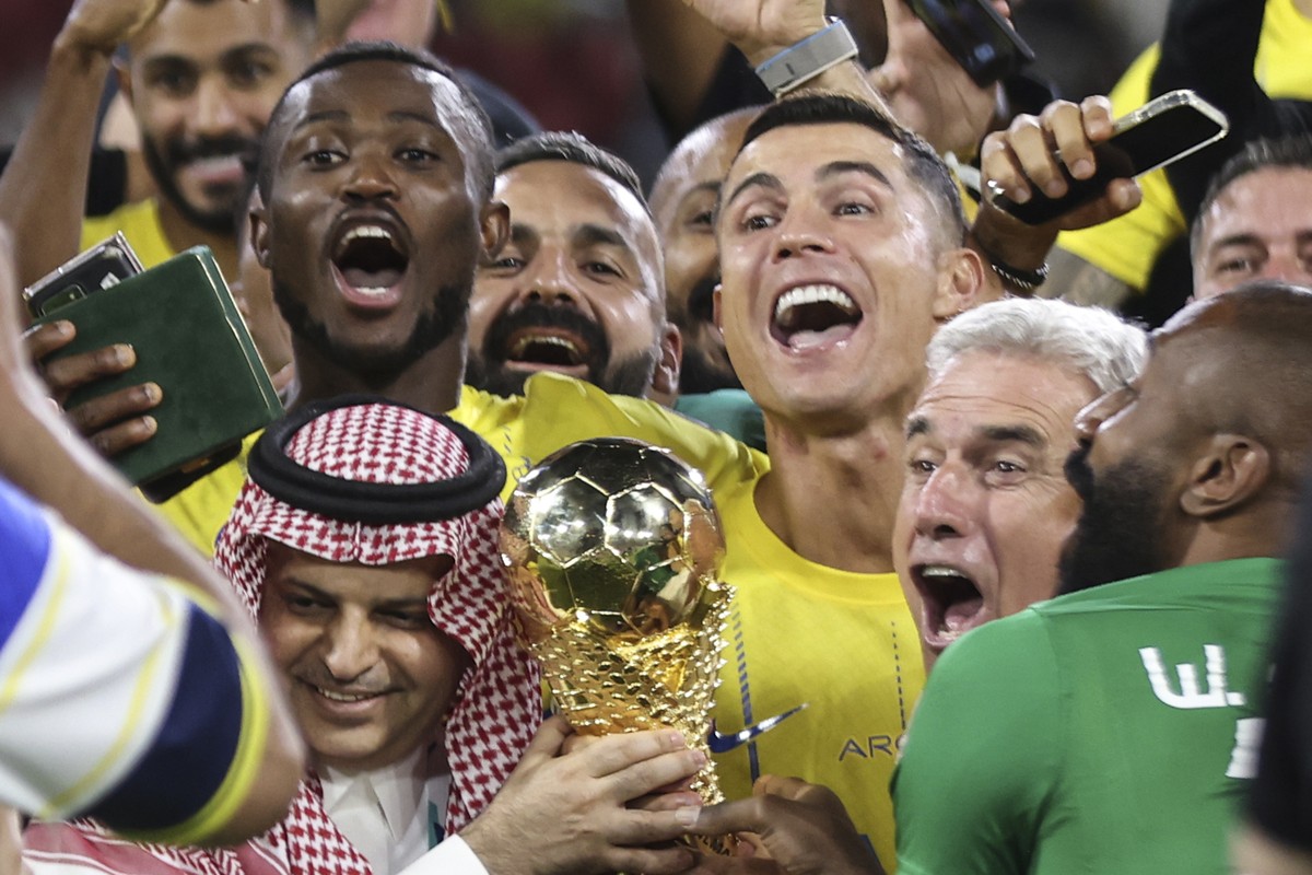 Al Nassr's Cristiano Ronaldo, and teammates celebrate with the trophy of the Arab Club Championship Cup at King Fahd Stadium in Taif, Saudi Arabia, Saturday, Aug.12, 2023. (AP Photo/Samah Zidan)
 ...