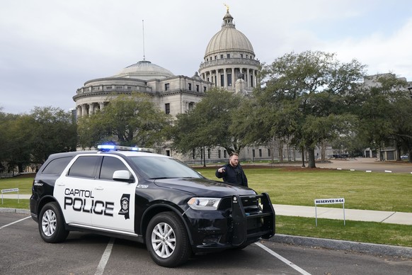 A Capitol Police officer warns passersby responding to a bomb threat at the Mississippi State Capitol in Jackson, Miss., Wednesday morning, Jan. 3, 2024. The building was cleared, the grounds...