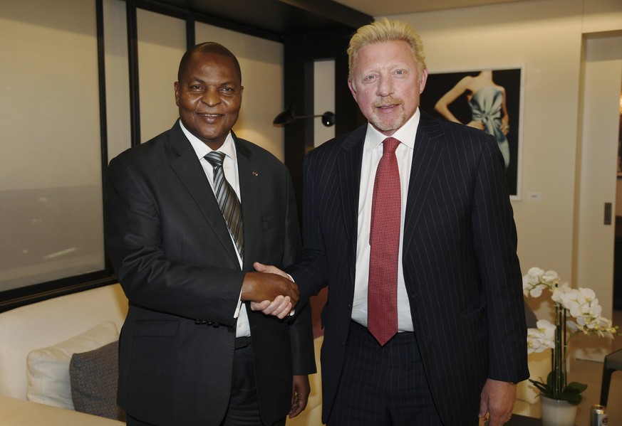 FILE - In this file photo originally released on Friday, April 27, 2018, President Prof. Faustin Archange Touadera, left, shakes hands with retired German tennis star Boris Becker in Brussels, Belgium ...