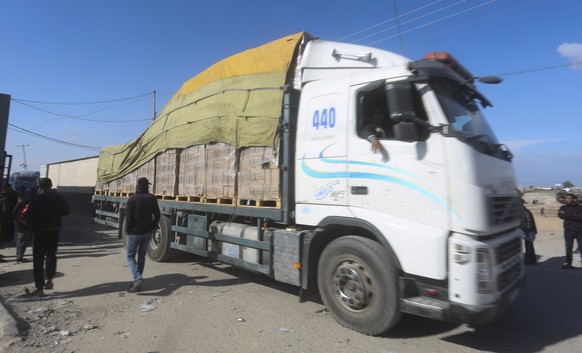 FILE - Humanitarian aid trucks enter the Gaza Strip from Israel through the Kerem Shalom crossing in Rafah on Sunday, Jan. 14, 2024. As the fighting rages on with no end in sight, the humanitarian cat ...