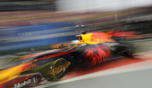 Red Bull driver Daniel Ricciardo of Australia steers his car out of his team garage during the third practice session at the Singapore Formula One Grand Prix on the Marina Bay City Circuit Singapore,  ...