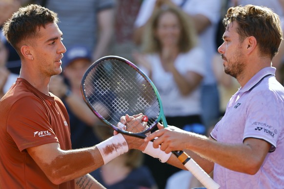 Australia&#039;s Thanasi Kokkinakis, left, and Switzerland&#039;s Stan Wawrinka shake hands after their second round match of the French Open tennis tournament at the Roland Garros stadium in Paris, W ...