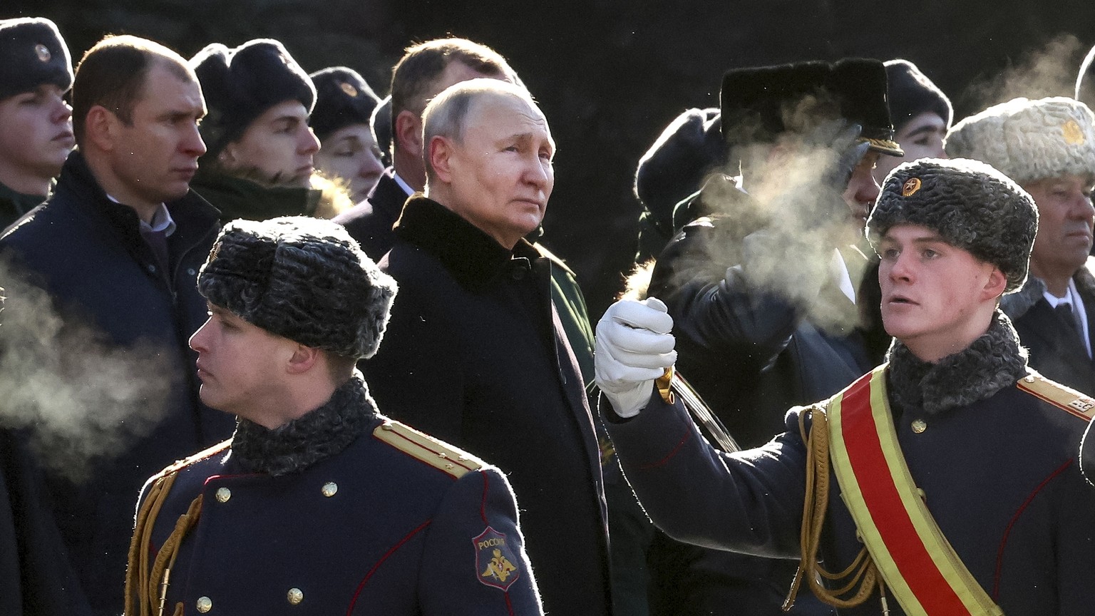 FILE - Russian President Vladimir Putin, center left, attends a wreath-laying ceremony at the Tomb of the Unknown Soldier, near the Kremlin Wall during the national celebrations of the &quot;Defender  ...