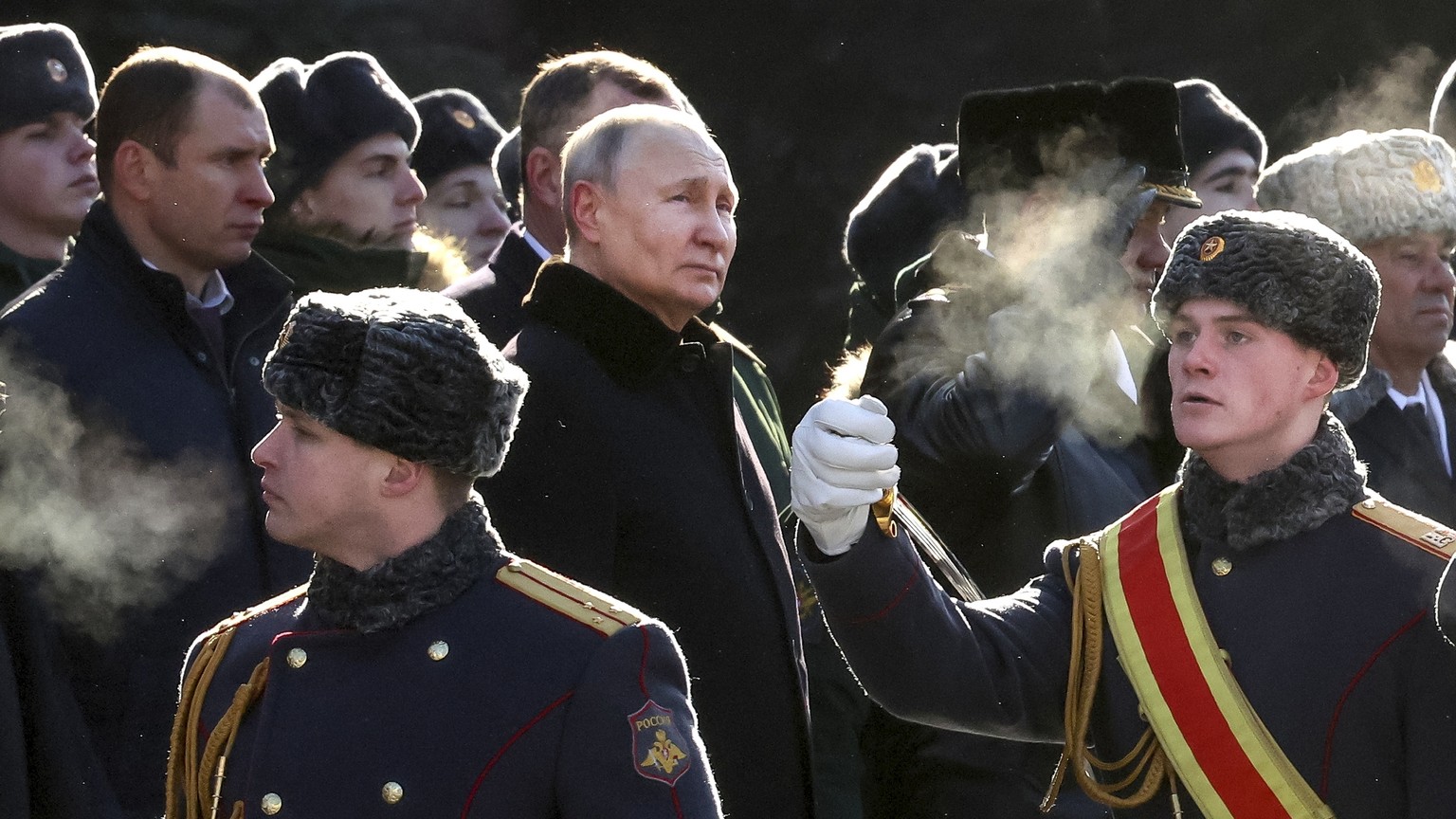 FILE - Russian President Vladimir Putin, center left, attends a wreath-laying ceremony at the Tomb of the Unknown Soldier, near the Kremlin Wall, during the national celebrations of the "Defender...
