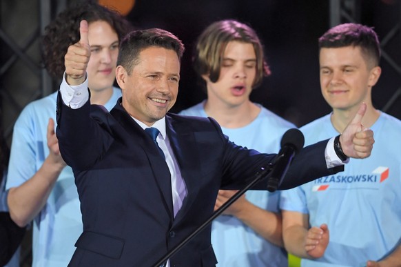 epaselect epa08542476 Mayor of Warsaw and candidate for Poland&#039;s president of main opposition party Civic Platform and Civic Coalition&#039;s Rafal Trzaskowski (C) reacts after initial exit polls ...