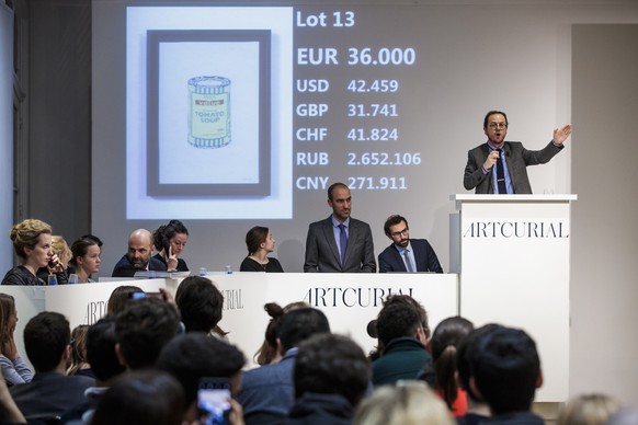 epa07117278 Auctioneer Arnaud Oliveux (R) leads the sale of the offset lithograph &#039;Soup can Yellow&#039; (2005) by British artist Banksy at the urban art auction held by Artcurial in Paris, Franc ...