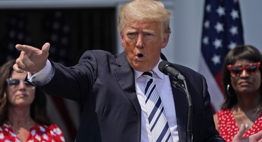 Former President Donald Trump imitates the shooting of a gun with his finger while talking about gun violence in Chicago as he speaks at Trump National Golf Club in Bedminster, N.J., Wednesday, July 7 ...
