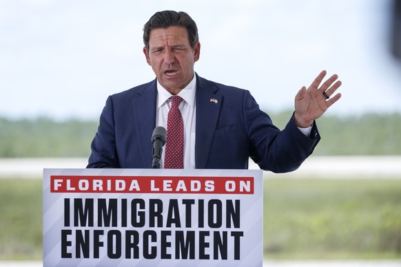 epa13064567 Florida Governor Ron DeSantis speaks during a press conference at the South Florida Detention Facility nicknamed ?Alligator Alcatraz? at the Dade-Collier Training and Transition Airport in ...