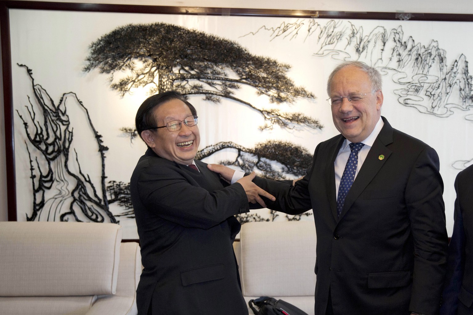 Switzerland&#039;s Federal President Johann Schneider-Ammann, right, enjoys a moment with China&#039;s Minister of Science and Technology Wan Gang during a visit to the ministry in Beijing, China, Fri ...