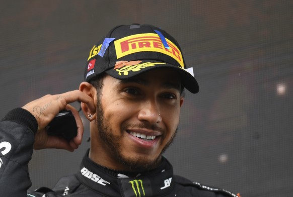 Mercedes driver Lewis Hamilton of Britain smiles after winning the Turkish Formula One Grand Prix at the Istanbul Park circuit racetrack in Istanbul, Sunday, Nov. 15, 2020. (Clive Mason/Pool via AP)