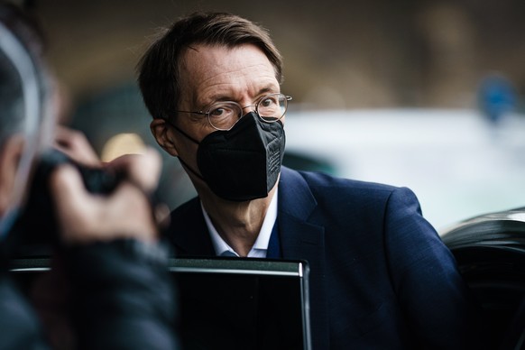 epa09685302 German Health Minister Karl Lauterbach steps into a car, as he leaves after the weekly press conference of the German health minister at the House of the Federal Press Conference (Bundespr ...
