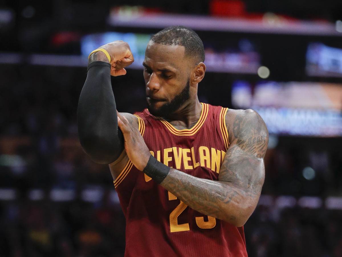 FLE - In this March 19, 2017, file photo, Cleveland Cavaliers' LeBron James flexes his arm after making a basket and drawing a foul call against the Los Angeles Lakers during the second half of a ...