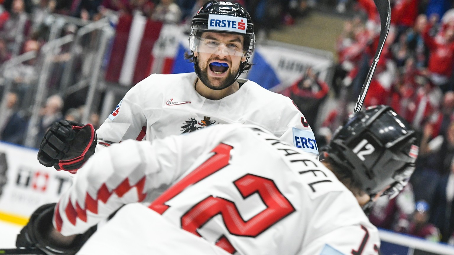 epa07562550 Michael Raffl of Austria (front) celebrates with Alexander Pallestrang of Austria (back) after scoring a goal during the IIHF World Championship group B ice hockey match between Latvia and ...