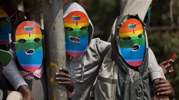 FILE - Kenyan gays and lesbians and others supporting their cause wear masks to preserve their anonymity as they stage a rare protest against Uganda's tough stance on homosexuality and in so…