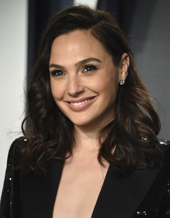 FILE - Gal Gadot arrives at the Vanity Fair Oscar Party on Sunday, Feb. 9, 2020, in Beverly Hills, Calif. Gadot is using her Hollywood star power to spotlight remarkable women from around the world. T ...