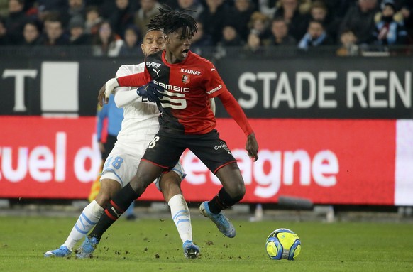 Rennes' Eduardo Camavinga, front, duels for the ball with Marseille's Jordan Amavi during the League One soccer match between Rennes and Marseille, at the Roazhon Park stadium in Rennes, Fra ...