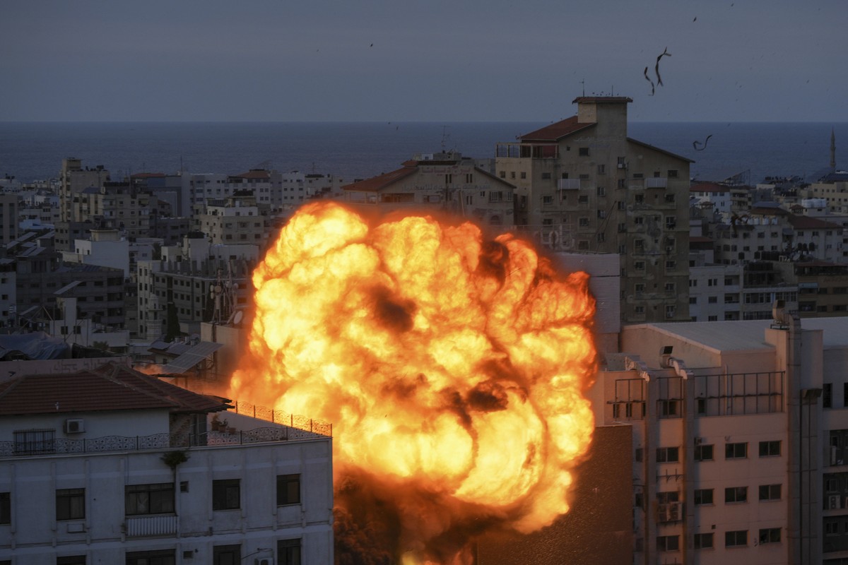 Fire and smoke rise following an Israeli airstrike, in Gaza City, Sunday, Oct. 8, 2023. The militant Hamas rulers of the Gaza Strip carried out an unprecedented, multi-front attack on Israel at daybre ...