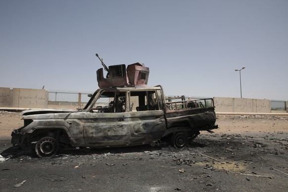 A destroyed military vehicle is seen in southern in Khartoum, Sudan, on April 20, 2023. The latest attempt at a cease-fire between the rival Sudanese forces faltered as gunfire rattled the capital of  ...
