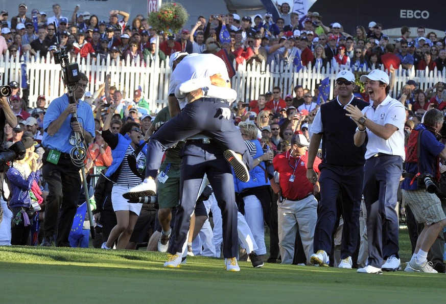 The 39th Ryder Cup 2012 Celebration after the final putt, Martin Kaymer that made it jumps in to the arms of Sergio Garcia to the right Peter Hanson and Rory McIlroy on the final day of the 39th Ryder ...