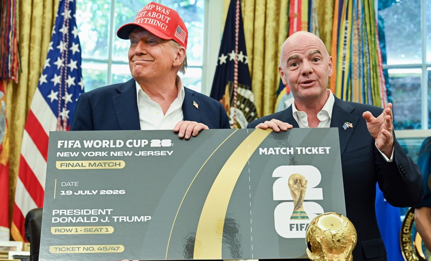 epa12317164 US President Donald Trump (L) and FIFA President Gianni Infantino (R) hold a ticket to the 2026 FIFA World Cup after after announcing the 2026 FIFA World Cup draw will be held at the Kenne ...
