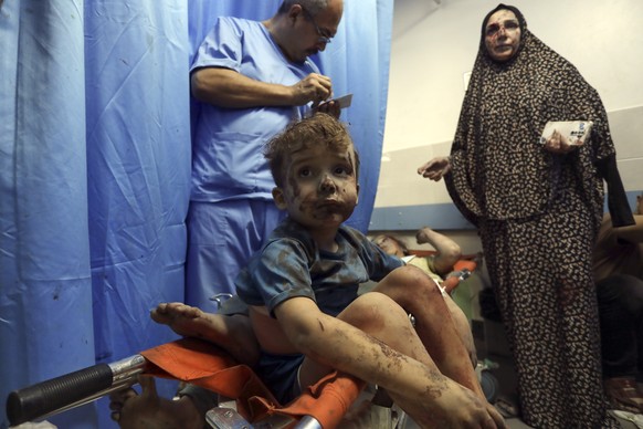 Wounded Palestinians are treated at al-Shifa hospital after Israeli airstrikes on Gaza City, Thursday, October 8.  August 26, 2023. (AP Photo/Abed Khaled)