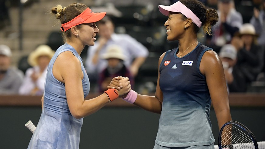 Belinda Bencic, of Switzerland, left, shakes hands with Naomi Osaka, of Japan at the BNP Paribas Open tennis tournament Tuesday, March 12, 2019 in Indian Wells, Calif. (AP Photo/Mark J. Terrill)