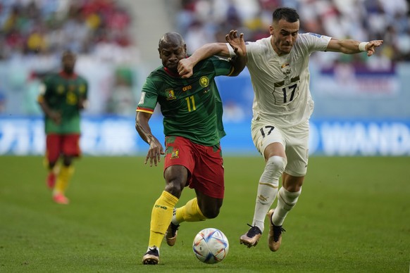 Cameroon&#039;s Christian Bassogog, left, fights for the ball with Serbia&#039;s Filip Kostic during the World Cup group G soccer match between Cameroon and Serbia, at the Al Janoub Stadium in Al Wakr ...