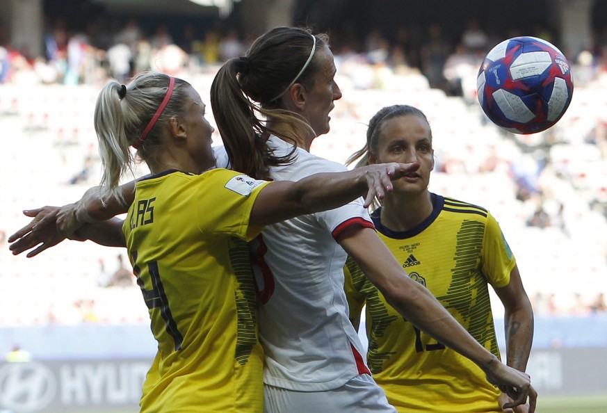 Sweden&#039;s Hanna Glas, left, Sweden&#039;s Nathalie Bjorn, right, and England&#039;s Jill Scott challenge for the ball during the Women&#039;s World Cup third place soccer match between England and ...
