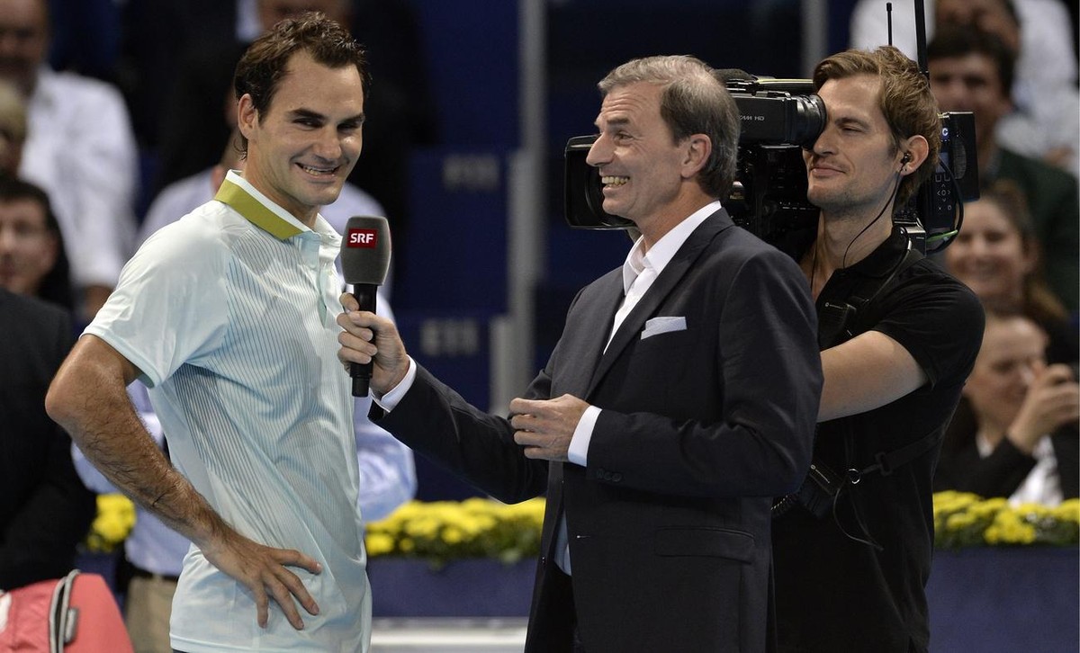Switzerland's Roger Federer, left, during an interview with Heinz Guenthardt, right, after his first round match against France's Adrian Mannarino at the Swiss Indoors tennis tournament at t ...