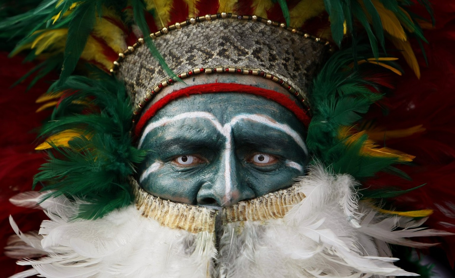 An Aztec dancer performs after arriving to the Basilica of Guadalupe in Mexico City, Sunday, Nov. 9, 2008, during an annual pilgrimage. Thousands of Aztec dancers dressed in feathers and beads danced  ...