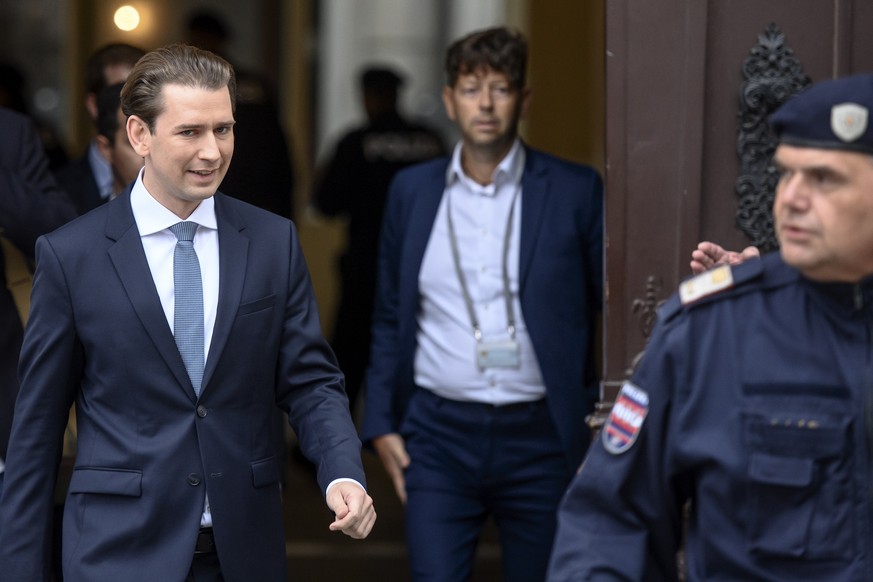 epa09511179 Austrian Chancellor Sebastian Kurz (L) crosses the Ballhausplatz square on his way to a meeting with Austrian President Alexander Van der Bellen at the Presidential Office, part of the Hof ...