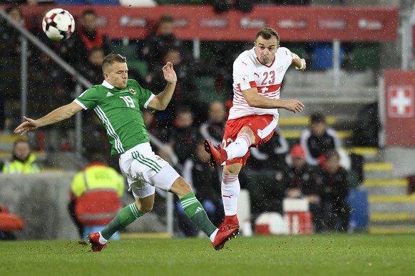 Northern Ireland&#039;s midfielder Jamie Ward, left, fights for the ball with Switzerland&#039;s midfielder Xherdan Shaqiri, right, during the 2018 Fifa World Cup play-offs first leg soccer match Nort ...