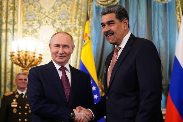 epa12080246 Russian President Vladimir Putin (L) shakes hands with Venezuelan President Nicolas Maduro during their meeting at the Kremlin in Moscow, Russia, 07 May 2025. Russia will mark the 80th ann ...