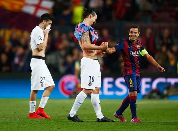 BARCELONA, SPAIN - APRIL 21: A victorious Xavi of Barcelona shakes hands with Zlatan Ibrahimovic of PSG during the UEFA Champions League Quarter Final second leg match between FC Barcelona and Paris S ...