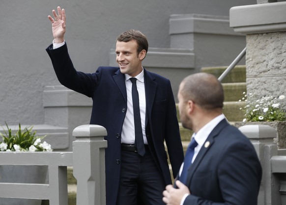 A bodyguard watches as centrist candidate Emmanuel Macron leaves his house after voting in the first round of the French presidential election, in le Touquet, northern France, Sunday April 23, 2017. ( ...