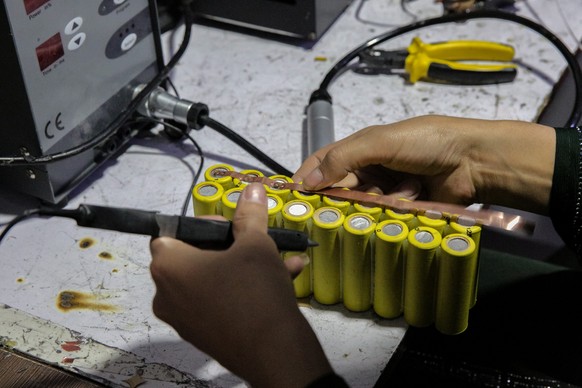 epa12065469 Zahra Ali, an Afghan girl, assembles power banks at her workshop in Kabul, Afghanistan, 30 April 2025. Zahra Ali, a 23-year-old innovator in Kabul, leads a team that produces homemade lith ...