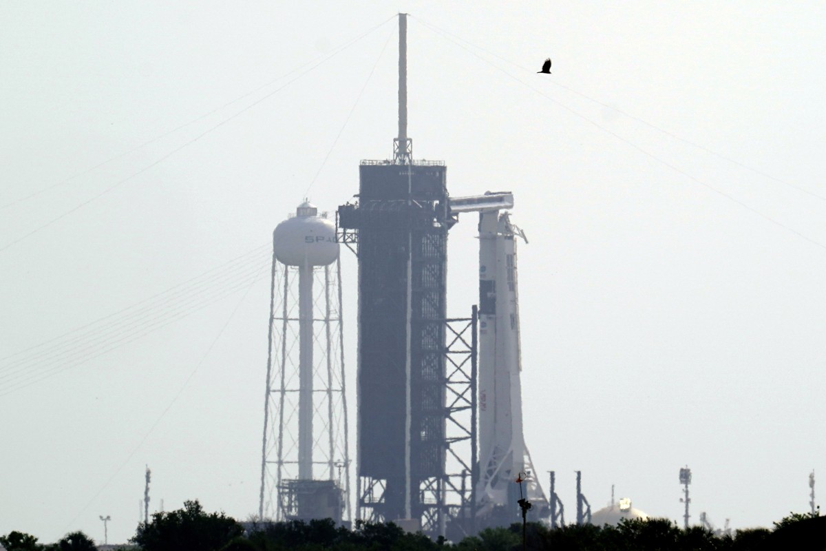 The SpaceX Falcon 9, with the Crew Dragon spacecraft on top of the rocket, sits on Launch Pad 39-A Thursday, May 28, 2020, at Kennedy Space Center in Cape Canaveral, Fla. Wednesday's planned laun ...