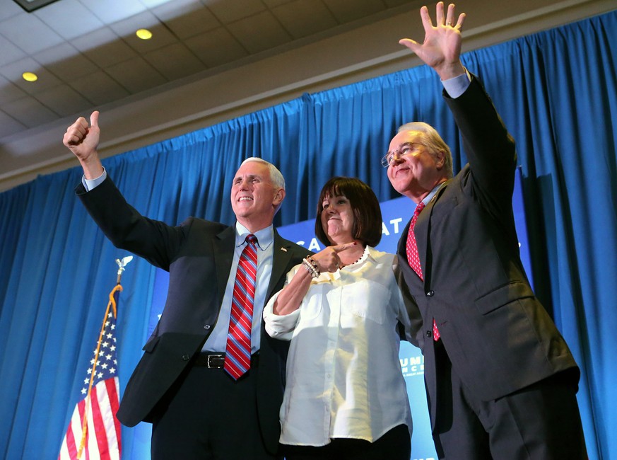 From left to right, Republican vice presidential candidate and Indiana Gov. Mike Pence, his wife Karen, and Congressman Tom Price make a campaign stop Monday, Aug. 29, 2016, in Marietta, Ga. (Curtis C ...