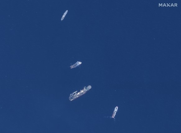 In this satellite image provided by Maxar Technologies, from top to bottom, the vessels L&#039;Atalante, Horizon Arctic, Deep Energy, and Skandi Vinland search for the missing submersible Titan, Thurs ...