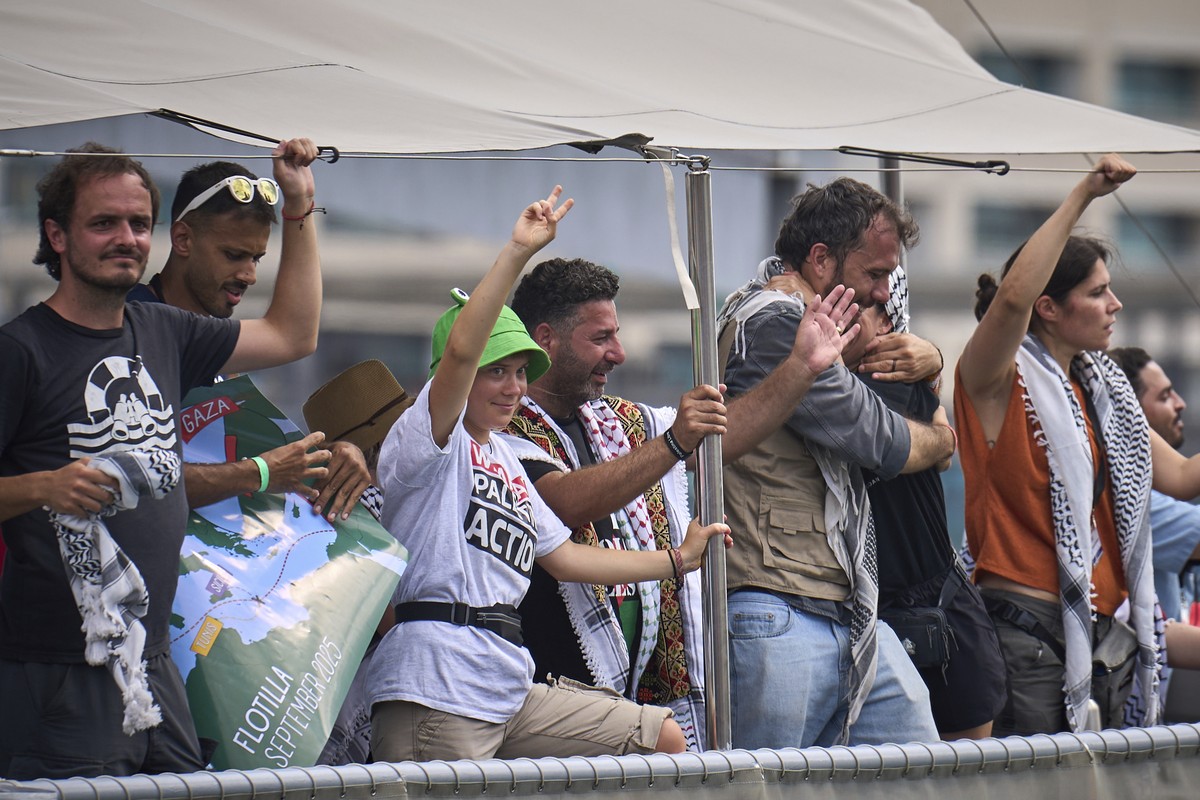 Swedish climate activist Greta Thunberg waves from a boat taking part in a civilian flotilla bound for Gaza, aiming to break the Israeli blockade and deliver humanitarian aid, in Barcelona, Spain, Sun ...
