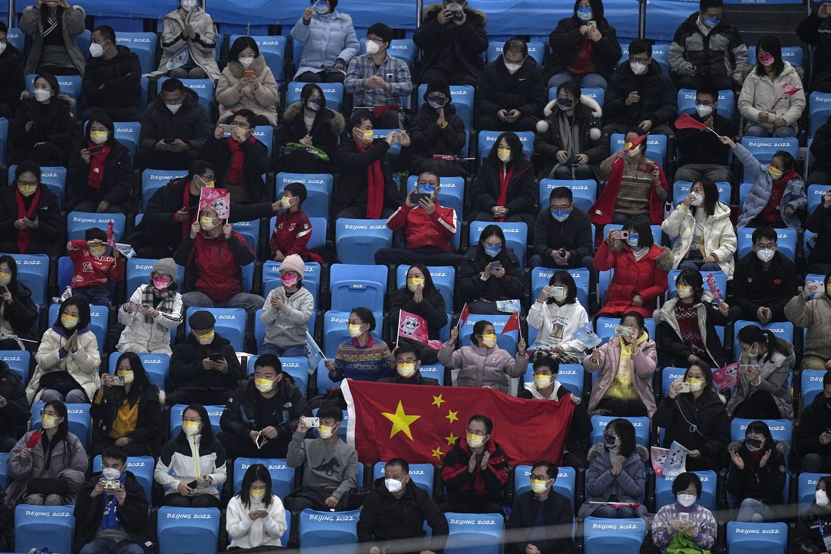Fans cheers for Jin Boyang, of China, in the men's free skate program during the figure skating event at the 2022 Winter Olympics, Thursday, Feb. 10, 2022, in Beijing. (AP Photo/Jae C. Hong)