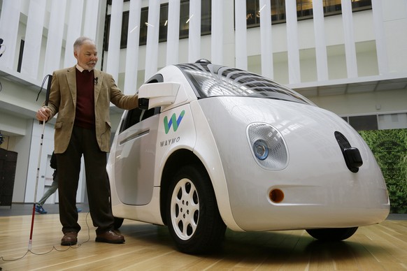 Steve Mahan, who is blind, stands by the Waymo driverless car during a Google event, Tuesday, Dec. 13, 2016, in San Francisco. The self-driving car project that Google started seven years ago has grow ...