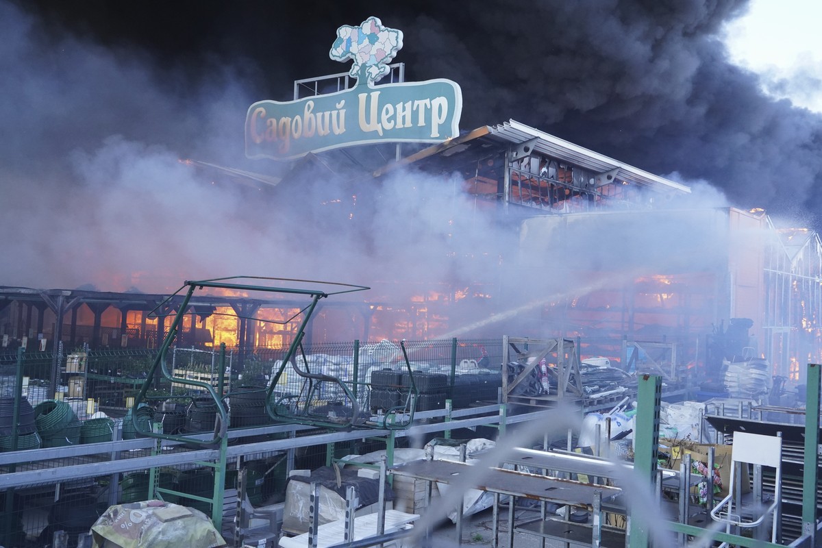 Firefighters put out a fire after two guided bombs hit a large construction supplies store in Kharkiv, Ukraine, Saturday, May 25, 2024. Writing reads "Garden Center". (AP Photo/Andrii Marien ...