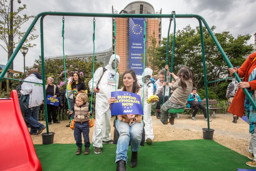 IMAGE DISTRIBUTED FOR AVAAZ - Members of global citizens&#039; movement Avaaz dressed up as crop sprayers in full chemical protection gear spray families in gas masks as part of a demonstration at the ...