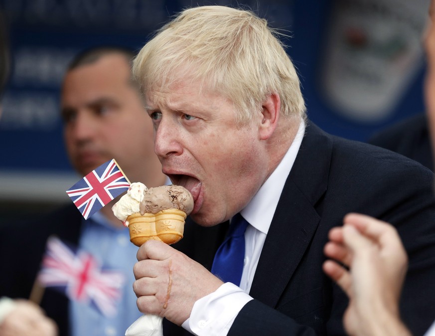 epa07699818 Conservative Party leadership candidate Boris Johnson eats an ice cream in Barry Island, Wales, Britain, 06 July 2019 ahead of the Conservative party leadership hustings in Cardiff. The tw ...