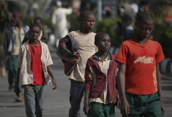 epaselect epa08891614 Released students walk together from a bus they where transported in with other students after their release, in Kankara, Katsina State, Nigeria, 18 December 2020. Some 300 Niger ...